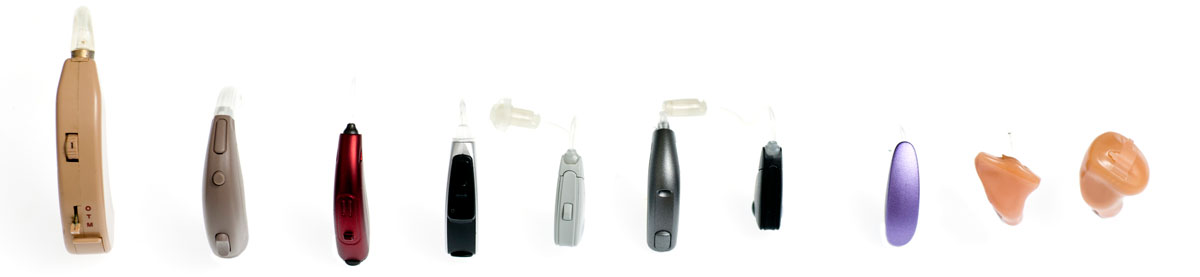 A selection of hearing aids of different sizes, models and colours